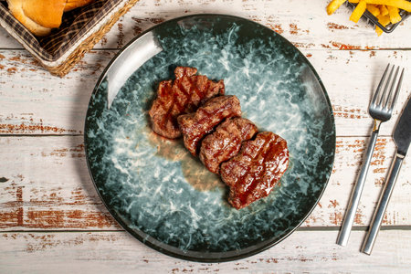 Freshly grilled beef tenderloin slices. Slices of cooked tenderloin on wood background. high quality photo. top viewの写真素材
