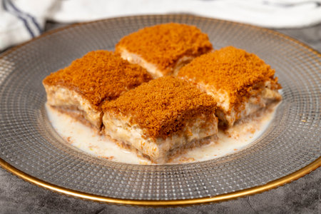 Cold baklava with biscuits. Cold baklava with biscuit filling on a dark background. local name cold baklava with lotus. Close upの写真素材
