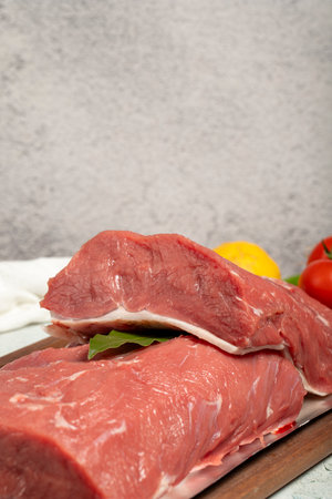 Beef sirloin. Butcher products. Raw beef sirloin or steak on a stone backgroundの写真素材