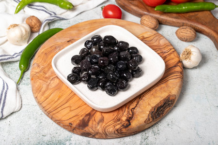 black olive Delicious olives grown in the Mediterranean region on a wooden serving boardの写真素材