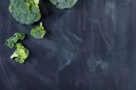 Curly kale and broccoli on blackboard from the topの写真素材