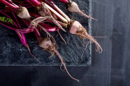Bunch of beetroots on the stone and blackboardの写真素材