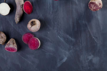 Sliced turnip and beetroots on blackboard from the topの写真素材