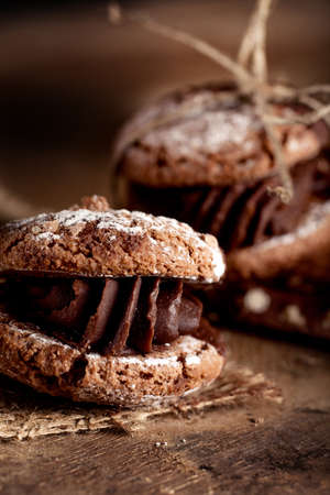 Italian maroni cookies with pieces of chocolate  on old wooden backgroundの写真素材