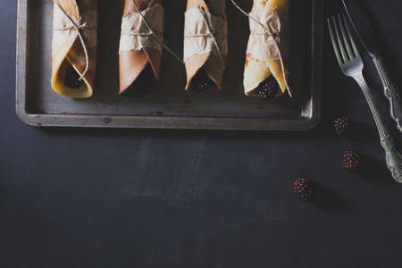 Pancakes with blackberries on rusty plateの写真素材