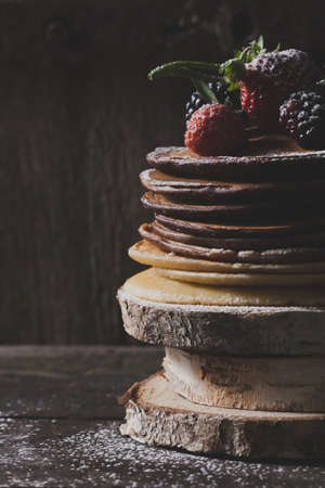 Chocolate pancakes on wooden blocksの写真素材