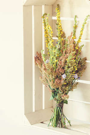 Bouquet from field flowers in white rustic boxの写真素材
