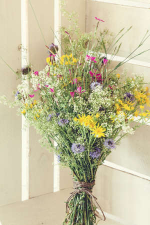 Bouquet from summer flowers in white rustic boxの写真素材