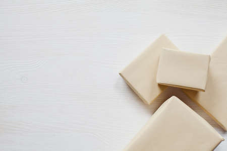 Four boxes on white, wooden tableの写真素材