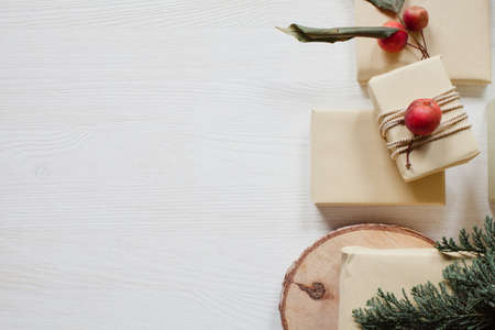 Rustic wrapped boxes with small apples and paper on white wooden tableの写真素材