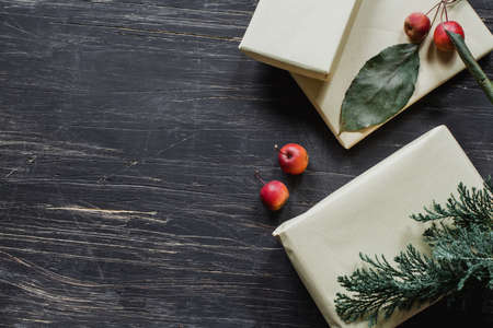 Christmas presents with apples and spruce on rustic tableの写真素材
