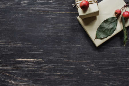 Rustic wrapped boxes with small apples on wooden table, top viewの写真素材