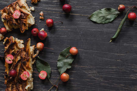 Apple tart on rustic, black wooden desk, top viewの写真素材