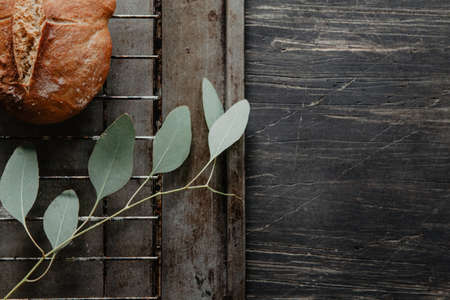 Traditional Irish soda bread made for St. Patrick's Day on vintage wooden table with eucalyptus...