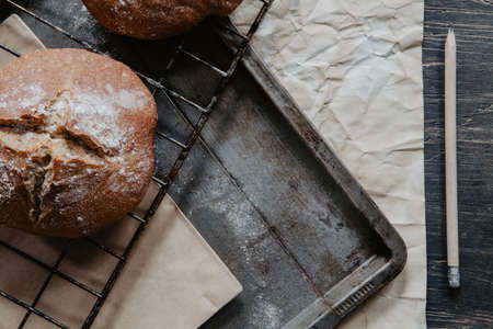 Homemade rustic bread on a baking tray with flour