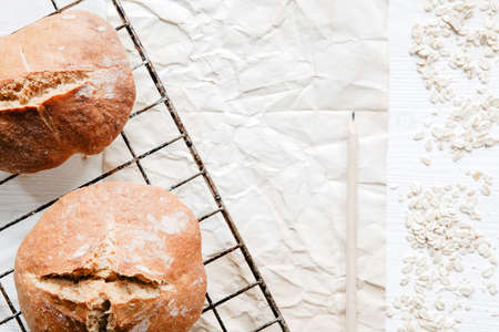 Irish soda bread in a rustic setting on cooling rack with paper and pencilの写真素材