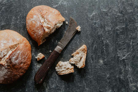 Traditional irish soda bread for St. Patrick's Day on black stone with knifeの写真素材