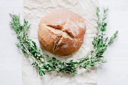 Easter bread with boxwood on rustic wooden backgroundの写真素材