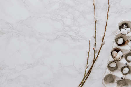 Easter decoration with natural materials like eggs and willow on marble table topの写真素材