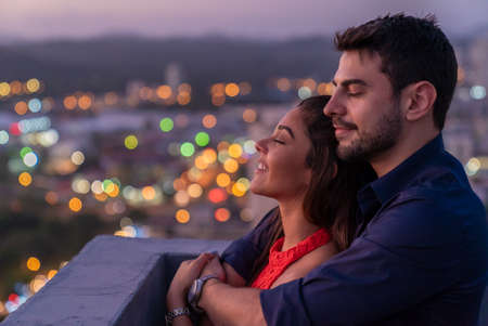 Couple Share Romantic Moment During Sunset in Rooftopの写真素材