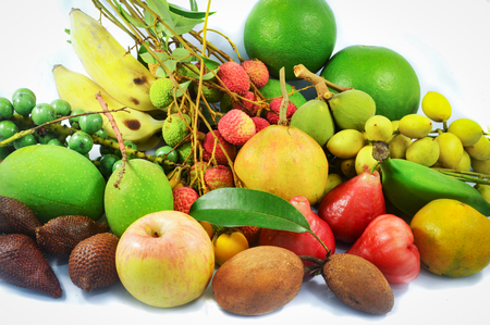 fresh tropical fruit / thailand local fruit organic mix pile on white background / colorful tropical fruit manyの写真素材