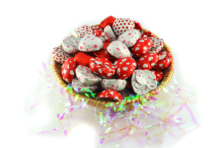 Candy Chocolate heart in Basket on white background isolatedの写真素材