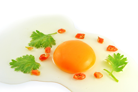 fresh egg yolks / raw egg broken whisk cooking food isolated on white background - crack eggs chicken with yolks with coriander chilliの写真素材