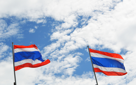 Thailand flag on sky / couple two of thailand flag on post with clouds and blue sky backgroundの写真素材