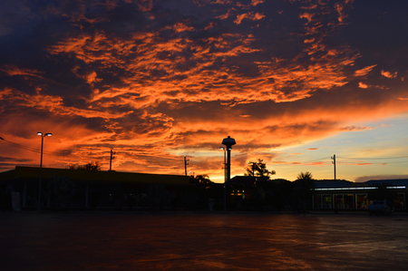 amazing cloud sky sunset / orange dark storm scary dramatic clouds on sunset beautiful with motion clouds over storm in summerの写真素材