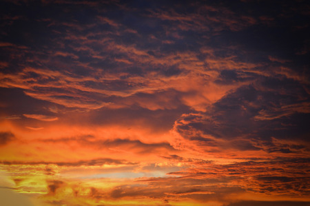 amazing cloud sky sunset / orange dark storm scary dramatic clouds on sunset beautiful with motion clouds over storm  texture backgroundの写真素材