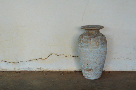 old pot vase classic / vintage vase old ceramic clay pot for flower on wall crack backgroundの写真素材
