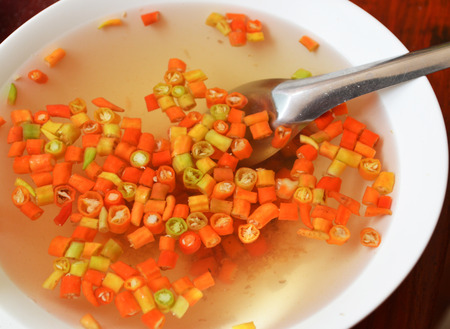 slice red chilli in vinegar / thai style food seasoning vinegar sour and spicy for noddlesの写真素材