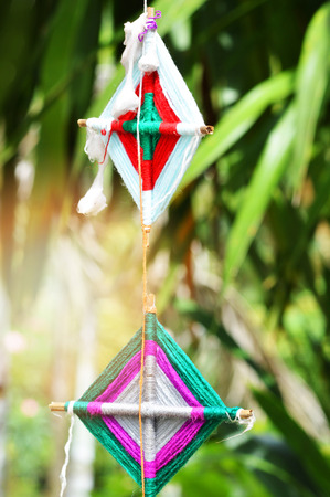 flags hanging in lanna art made in the northern region of thailand made from wood thread fabric colorful hanging down to decorate in the parkの写真素材