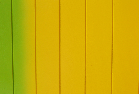 wooden yellow and green wall texture background / wall painted with  yellow and green on backgroundの写真素材