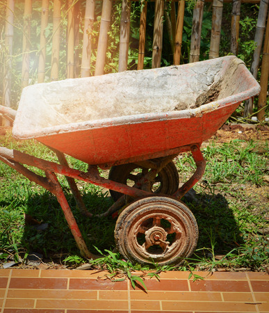 mortar cart cement for construction or agriculture / the old orange cart for concrete cement in the backyardの写真素材