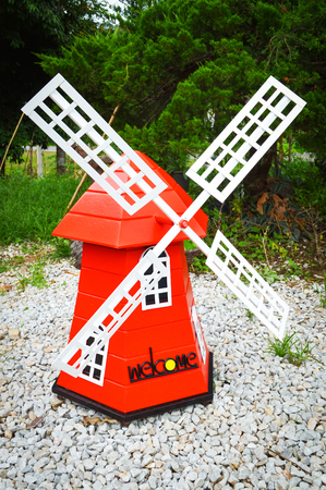 colorful red windmill wind turbine in the park garden - landscape windmill nature hill backgroundの写真素材