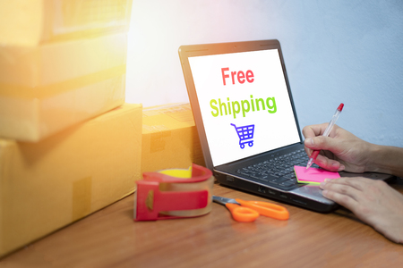 free shipping laptop selling things online ecommerce delivery shopping online and order concept / box parcels on table packing shipping for customer shopping online in cardboard boxの写真素材
