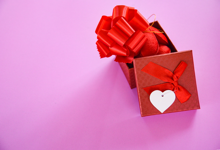 Open Gift Box red Valentines day concept / Red present box with ribbon bow and red Heart full gift box on pink background - Surprise Gift Box Festival for loverの写真素材