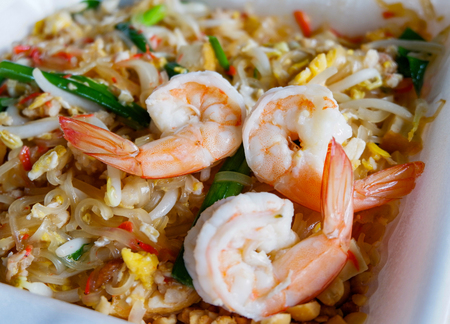 pad thai noodles shrimp / stir fried noodles with bean sprouts egg spring onion and shrimp cocktail - thai style foodの写真素材