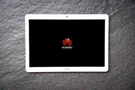 Bangkok, Thailand - January 28, 2019 : New computer Tablet huawei mediapad t3 10 inch white color with display screen front HUAWEI logo on dark stone backgroundのeditorial素材