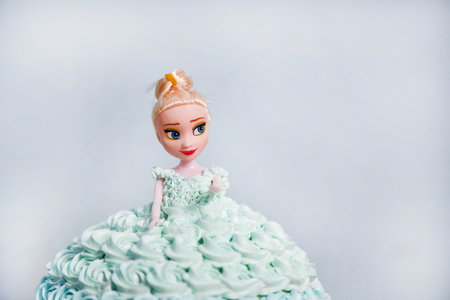 Blue cream cake doll wedding or cake for girls at birthday on gray backgroundの写真素材