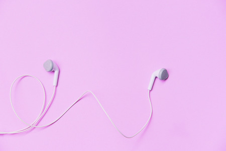Earphons on pink background /  Music is my life and Entertainment listen to music concept with white earphones on top viewの写真素材
