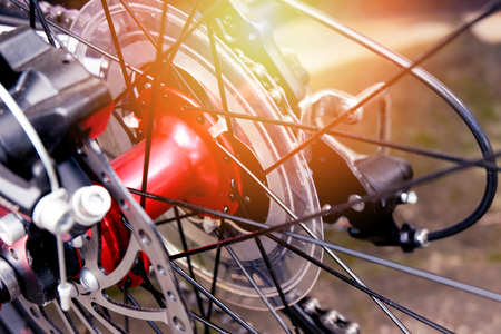 bicycle wheel hub details / close up rear mountain bike back wheel red with chain bike gearshift mechanism vintage colorの写真素材