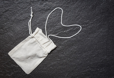 White tote canvas fabric eco bag cloth on dark background / Zero waste Use less plastic say no plastic bag pollution problem conceptの写真素材