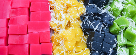Colorful Thai dessert background with pink classy sweets , black and green coconut shredded pudding...