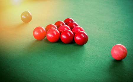 Red and black Snooker ball set on green snooker table - billiards game vintage color styleの写真素材