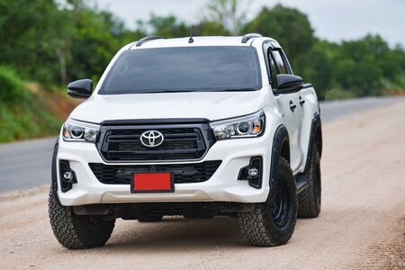 Bangkok Thailand - July 27 2018 : New Toyota Hilux Revo Rocco white Pickup  Truck Offroad Car double cab 4x4 On a dirt road car brand from Japan basedのeditorial素材