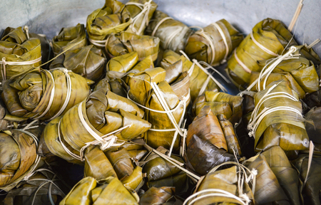 Thai dessert wrapped with banana leaf in sticky rice and banana after steamの写真素材