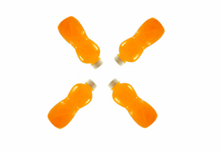 Orange juice fruit in four plastic bottle isolated on white background