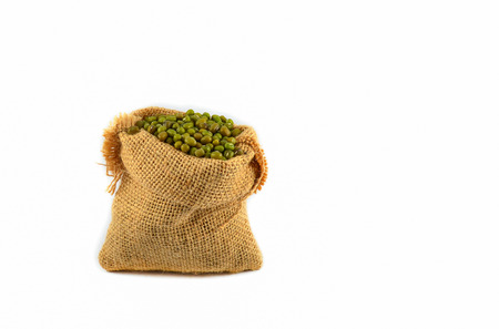 Mung beans in sack isolated on white backgroundの写真素材